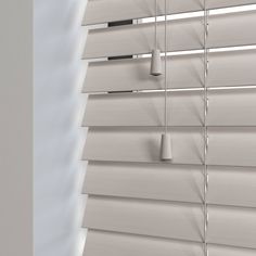 the blinds are closed and ready to be used in an office or living room with white walls