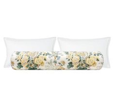 two white pillows with yellow roses on them