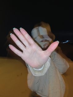 a person is holding their hand out in front of the camera with both hands extended