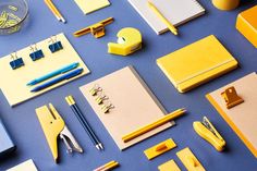 various office supplies laid out on a blue surface