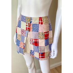 Adorable late 60s / early 1970s mini skort. Colorful patchwork print with plaids & calico. It has gold buttons (non functional) , it's split in the front showing the attached white shorts. Zips up the back. Thick poly/cotton blend material In excellent condition SIZE : no size tag, fits like an Xs Measurements : Waist 26 HIPS : up to 40 LENGTH : 13 INSEAM : 2.75 I aim to provide accurate descriptions and measurements. To best determine size, compare measurements to a similar garment you own that Retro Cotton Patchwork Shorts, Retro Patchwork Cotton Shorts, Retro Cotton Skort In Short Length, Retro Cotton Mini Skort, Cotton Retro Skort, Retro Plaid Mini Skirt For Summer, Multicolor Mini-length Cotton Skort, Vintage Style Fitted Cotton Skort, Multicolor Mini Length Cotton Skort