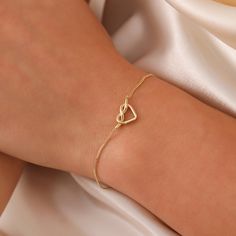 Tiny Knot Bracelet, 14K Solid Gold Heart Knot Bracelet, Dainty initial Unique Love Bracelet, Handmade 14K Gold Knot Bracelet, Great Gift For Her, Summer Jewelry, Anniversary Bracelet, Birthday Gift, Christmas Gift, Solid Gold Bracelet, Minimalist Gold Bracelet, Wedding Bracelet, Valentine's Day Gift "Material: SOLİD GOLD (No Gold Filled Or No Gold Plated)" "KARAT: 14K (585) "Bracelet Length: 11 MM "Bracelet Width: 7,5 MM "Available Gold Color: (Yellow Gold, White Gold, Rose Gold) "The certificat Delicate Yellow Gold Heart Bracelet For Anniversary, Elegant Open Heart Bracelets For Mother's Day, Minimalist Heart Bracelet With Adjustable Chain For Anniversary, Yellow Gold Heart Bracelet For Mother's Day, Elegant Open Heart Bracelets, Elegant Yellow Gold Open Heart Bracelet, Delicate Gold Heart Bracelet For Anniversary, Elegant Open Heart Bracelets For Everyday, Dainty Yellow Gold Heart Bracelet For Mother's Day