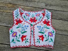 "Famous vintage handembroidered vest with authentic Hungarian pattern.  Vest : Bust : 32 - 33\" Lenght : 14\"   Hand washes only. If you are buying several pieces I can combine postage at the time of mailing. If you have any question please don't hesitate to contact me,  My Etsy shop: https://www.etsy.com/shop/TreasuryCoffer" Folk Style Embroidered Vest, Bohemian Vest With Multicolor Embroidery For Spring, Folk Style Cotton Vest With Floral Embroidery, Fitted Cotton Vest With Floral Embroidery, Vintage Sleeveless Vest With Floral Embroidery, Folk Style Sleeveless Vest With Multicolor Embroidery, Folk Style Vest With Multicolor Floral Embroidery, Traditional Embroidered Summer Vest, Fitted Bohemian Vest With Floral Embroidery