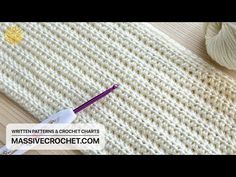 the crochet pattern is being used to make a knitted blanket with yarn needles