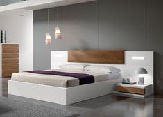 a modern bedroom with white and wood furniture