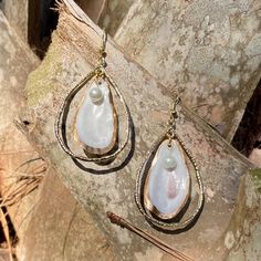 Unique oyster shell gold teardrop hoop earrings with round pearl. Small oyster is gold backed with gold outline on front. Hoop size is 2 inches in length by 1 1/4 in width which does not include the drop length. These earrings are light weight and can be dressed up or worn casual. Oyster shells are found in coastal Georgia. Each oyster is unique in color, shape and size. I will be happy to send a picture of the exact earrings before you purchase them. I also create custom orders. Gold Oyster Necklace, Handmade Gold Shell-shaped Earrings, Gold Ocean-inspired Shell Drop Earrings, Summer Gold Shell-shaped Pearl Earrings, Elegant Shell-shaped Earrings With Pearl Charm, Oyster Shells, Oyster Shell, Jewelry Earrings Hoops, Teardrop Earrings