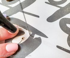 a person is using a marker to paint the letters