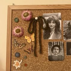 a cork board with pictures, flowers and buttons attached to the corks on it