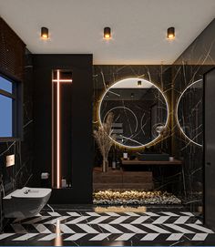 a modern bathroom with black and white tile flooring, round mirrors on the wall