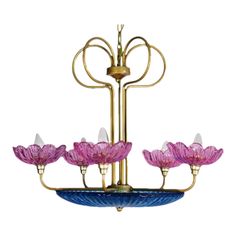 a chandelier with pink flowers hanging from it's arms and four lights on each end