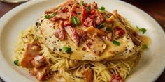 a white plate topped with chicken and pasta