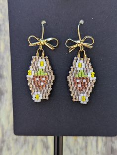 Delicate, dainty, and adorable, these earrings feature pearlescent red strawberries with petite white strawberry blossoms hanging from ear wires adorned with tiny golden bows. Lightweight for everyday wear.  These are handwoven with high-quality Japanese Miyuki Delica glass seed beads, prized for their high quality finishes, durability, and uniform size. Each bead is individually inspected and woven in with durable nylon thread. All metals are certified hypoallergenic, nickel and lead free. Colors: Pale pink, champagne, white, crystal red, light green, yellow, and gold Note: Please message me or leave a note to seller when purchasing if a different earring hardware or metal is needed. Hypoallergenic ear wires come standard. Lever backs and other types are available upon request. Clip-on op Flower Drop Earrings With Dangling Beads For Gifts, Beaded Teardrop Flower Earrings As Gift, Beaded Teardrop Flower Earrings For Gift, Adjustable Flower Earrings With Dangling Beads For Gifts, Seed Bead Strawberry, Bead Strawberry, Golden Bow, White Strawberry, Red Strawberry