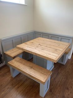 a wooden table and benches in a room