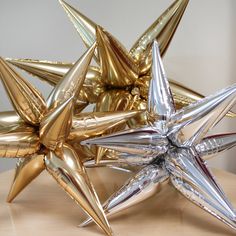 some shiny gold and silver stars on a table