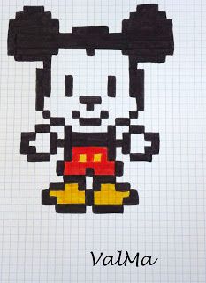 a cross - stitch mickey mouse is shown with crayons on the table next to it