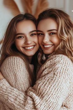 two girls hugging each other and smiling