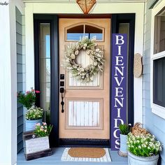 a front door with a welcome sign on it and two potted plants next to it