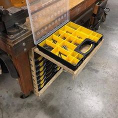 an open tool box sitting on top of a workbench