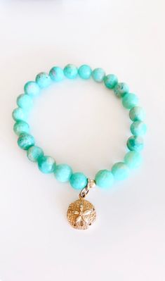 Amazonite - Soothes the spirit and calms the soul, connected with warrior women, feel the calm and power when you wear this stone. 8mm Faceted beads on a strong stretch cord. Choose the charm of your choice! I chose the sand dollar, legend told that its mermaid coins and a symbol of the Easter story. Open it up and 5 tiny doves come out. I love the freedom and protection of that ;) Spiritual Amazonite 8mm Beads Jewelry, Casual Turquoise Jewelry For Healing, Spiritual Amazonite Jewelry With 8mm Beads, Hand-strung Charm Bracelet With Round Beads For Healing, Adjustable Stretch Bracelet With Amazonite Gemstone Beads, Adjustable Amazonite Gemstone Beads Stretch Bracelet, Spiritual 8mm Beads Jewelry For Beach, Spiritual Charm Bracelet With 8mm Beads For Healing, Adjustable Turquoise Stretch Bracelet For Meditation