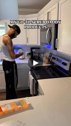 a man standing in a kitchen next to a stove top oven