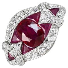 A captivating gemstone ring featuring a 1.08-carat oval cut natural ruby as the centerpiece. The striking design includes geometric arrangements of French cut rubies on either side, complemented by an old European cut diamond halo. Additional elegance is added with single French cut rubies and more old European cut diamonds on each shoulder. The total diamond weight is around 0.84 carats. Handcrafted in platinum, the ring boasts intricate openwork on the under-gallery. Ring Size: 6.5 US, Resizab Heirloom Oval Gia Certified Ruby Ring, Oval Ruby Diamond Ring, Oval Ruby Ring With Platinum Band, Oval Ruby Ring With Platinum Setting, Heirloom Oval Ruby Ring Gia Certified, Red Oval Diamond Cut Diamond Ring, Red Oval Diamond Cut Ring, Red Oval Diamond Ring With Diamond Cut, Art Deco Oval Ruby Ring For Anniversary