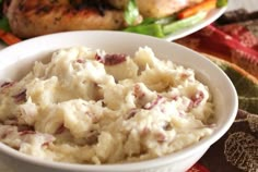 a bowl filled with mashed potatoes on top of a table