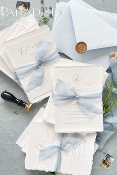 the wedding stationery is laid out on top of each other