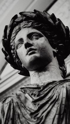 a black and white photo of a statue in front of a building