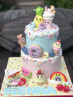 a birthday cake decorated with donuts, fruit and ice cream