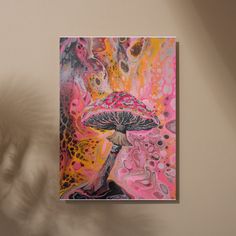 a painting hanging on the wall next to a potted plant