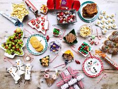 a table topped with lots of different types of food and desserts on top of it