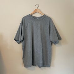 This Is A Heavy Fit T-Shirt. Never Worn! Gray Crew Neck T-shirt For Loungewear, Sporty Plain T-shirt With Relaxed Fit, Sporty Relaxed Fit Plain T-shirt, Uniqlo Graphic Tee With Crew Neck, Sporty Plain Short Sleeve T-shirt, Sporty Crew Neck Shirt For Everyday, Plain Cotton T-shirt For Loungewear, Uniqlo Relaxed Fit Crew Neck T-shirt, Casual Solid Color Tops By Uniqlo