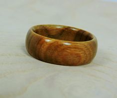 Men's Wood Ring - Wood Wedding Band - Handmade Wood Ring Looking for a gorgeous alternative wedding band? Look no further than this eco friendly handmade vera wood ring. It's warm honey brown color and smooth finish make it perfect for either men or women and for any occasion- extremely versatile! Use it as a men's or women's wedding band or engagement ring, girlfriend or boyfriend gift, anniversary gift, or as a standout everyday ring. Made from durable vera wood (Argentine lignum vitae), this Mens Wood Rings, Lignum Vitae, Nature Inspired Accessories, Wooden Rings Engagement, His And Hers Rings, Alternative Wedding Bands, Wooden Wedding Ring, Wood Wedding Ring, Wood Wedding Band