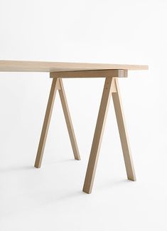 a wooden table sitting on top of a white floor