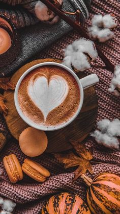 a cappuccino with a heart in the foam surrounded by nuts and cotton