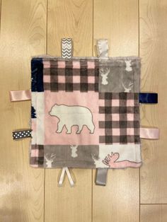 a pink and black patchwork quilt with a polar bear on it's side