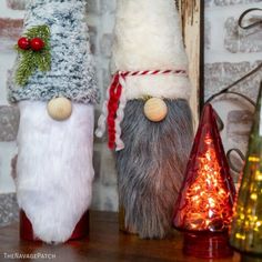 two christmas decorations are sitting on a shelf