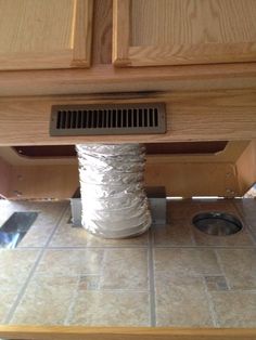 a roll of duct tape is wrapped around the base of a cabinet in a kitchen