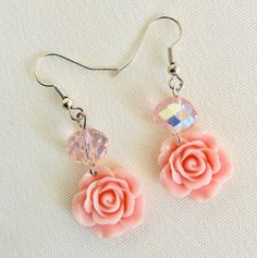 pink rose earrings with swarong crystals and crystal bead dangles on white background