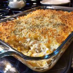 a casserole dish with chicken and cheese in it on the stove top, ready to be eaten