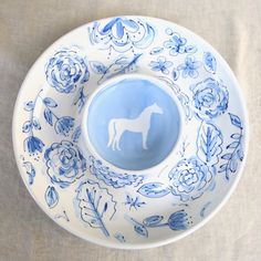 a blue and white plate with a horse on it