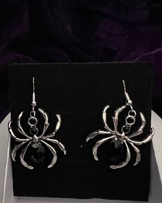 These spider-themed dangling earrings feature hooks made of 925 silver, making them an excellent choice for those with sensitive ears. The intricate design adds a touch of elegance and uniqueness to your style. Gothic Sterling Silver Earrings For Parties, Halloween Sterling Silver Dangle Earrings, Gothic Sterling Silver Hypoallergenic Earrings, Halloween Silver Drop Earrings, Gothic Hypoallergenic Sterling Silver Earrings, Silver Drop Earrings For Halloween, Elegant Adjustable Halloween Earrings, Silver Earrings For Halloween Gift, Silver Pierced Earrings For Halloween