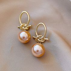 These earrings were designed to add a unique twist to the must-have pearl trend. Classic, timeless, and guaranteed to elevate any look. Copper plated Simulated pearls Size: 1.8in x 0.5in Pushback stud closure Hypoallergenic, lead & nickel free If you aren't in LOVE with your purchase, please let us know within 30 days of receiving your item, and you'll receive a stress-free refund. Pearl Trend, Dorothy Dandridge, Classy Earrings, Gold Pearl Earrings, Pretty Jewellery, Ear Jewelry, Tahiti, Bling Bling, Free Jewelry