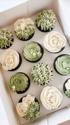 twelve cupcakes in a box decorated with green and white frosting, on top of each other