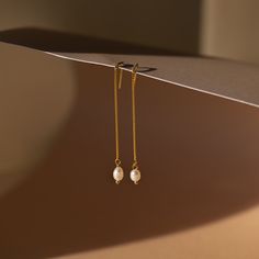 It’s as easy as pie to throw on our Pearl Threader Earrings and put an outfit together. Glamorous and dainty, these dangling charm earrings are minimalistic and perfectly stack with other earrings in your collection. Material: High Quality Solid 925 Sterling Silver Finish: 18K Gold ∙ Sterling Silver Featuring ~0.7mm Thick Chain Earrings ~60mm in Length, with a ~5.5x4.5mm Pearl Charm Sold as a pair Part of our Pearl Collection Model showcases a glamorous, event-ready look featuring Pearl Station Minimalist Single Pearl Earring For Everyday Elegance, Minimalist Pearl Drop Earrings For Everyday Elegance, Minimalist Everyday Pearl Drop Earrings, Tarnish Resistant Dangle Pearl Earrings For Everyday, Everyday Tarnish Resistant Dangle Pearl Earrings, Minimalist Long Drop Tarnish Resistant Earrings, Everyday Dainty Dangle Linear Earrings, Minimalist Tarnish Resistant Dangle Threader Earrings, Minimalist Gold Plated Threader Earrings