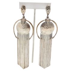 Get your hands on the Jean Paul Gaultier 1990s Silver Fringe Hoop Dangle Earrings, a stunning pair of statement earrings that reflect the artistry and iconic design of this renowned fashion designer. These earrings are the work of Jean Paul Gaultier, a legendary designer known for his innovative and daring fashion creations. Owning a piece from such a prestigious designer is a testament to your fashion-forward style. The bold design of these earrings, featuring silver O rings and circle charms w Hoop Dangle Earrings, Iconic Design, Paul Gaultier, Bold Design, Jean Paul, Jean Paul Gaultier, O Ring, Hands On, Fashion Designer