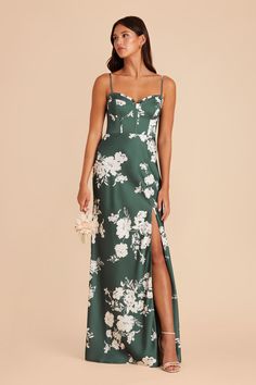 a woman wearing a green and white floral print dress with thigh high slited sandals