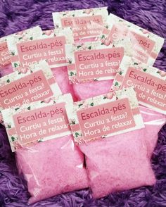 five bags of pink sugar sitting on top of a purple blanket