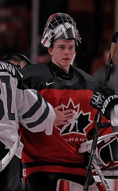 two hockey players standing next to each other