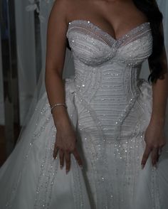 a woman in a wedding dress posing for the camera